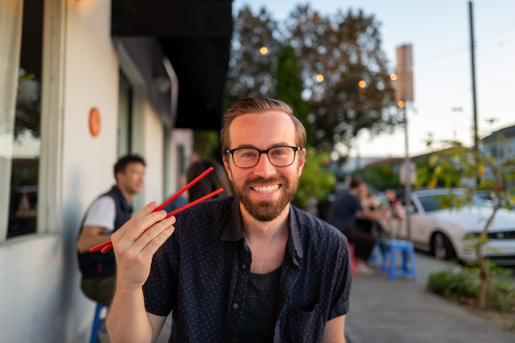 Patrick smiling at an outdoor dinner.