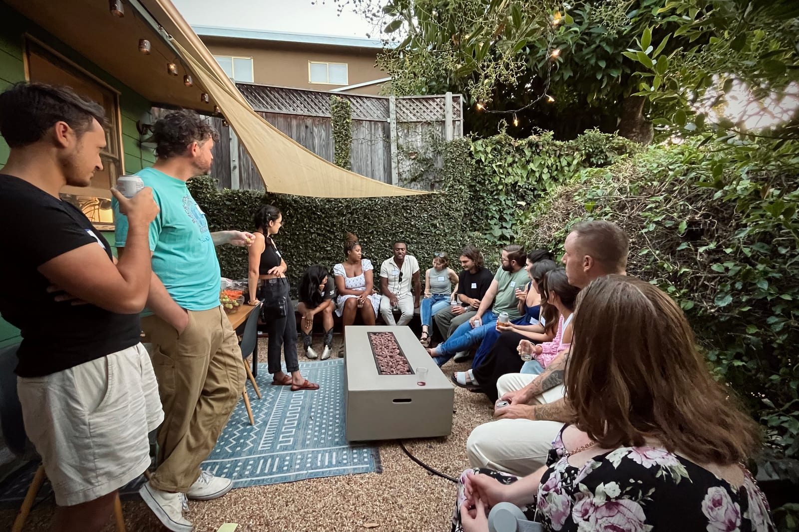 A backyard conversation circle at a creative community gathering.