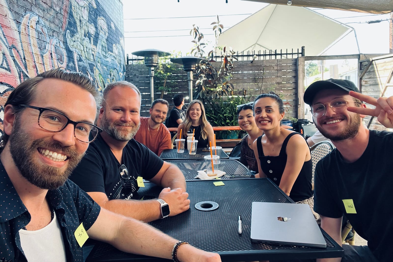 A small creative gathering around a patio table.